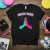 Black t-shirt with "HIGH FIVE" text in retro font above a teal and pink high five graphic with yellow accents