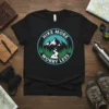 Hike More Worry Less quote on a black t-shirt with a circular mountain and forest graphic