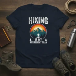 Hiking Is My Retirement Plan t-shirt design featuring a hiker silhouette against a mountain sunset graphic