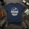 Hiking Makes Life Better text with mountain and forest graphic on a navy blue t-shirt