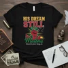 Black t-shirt with "His Dream Still Matters Martin Luther King Jr." text, featuring a raised fist, dove, and halo graphic