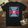 Black t-shirt featuring a blue and white road sign graphic that reads "HISTORIC ROUTE DH DIXIE HIGHWAY"