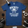 Hockey It's Like Football But For Men text with hockey helmet and crossed sticks graphic on a blue t-shirt