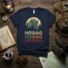 HODAG HODAG HODAG text in vintage colors with a green hodag monster graphic above, on a navy t-shirt