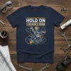 Navy t-shirt with "HOLD ON I CAN MAKE IT WORSE" text above a cartoon monkey driving a chaotic machine with
