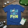 Hole In Fun text with cartoon golf ball and trophy on a blue t-shirt, golf theme design