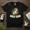 Black t-shirt with "HOLY COW" text and a jumping cartoon cow graphic, featuring yellow sunburst rays