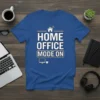 Blue t-shirt with white text "HOME OFFICE MODE ON" and minimalist computer and coffee cup graphics