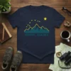 Homer Alaska t-shirt featuring a teal mountain range silhouette with yellow stars above and the text HOMER, ALASKA