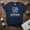 Navy blue t-shirt featuring white text "HOMETOWN DENTAL PARTNERS" and a stylized tooth logo with "HDP" inside