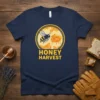 HONEY HARVEST text with a bee and honeycomb graphic on a navy blue t-shirt