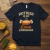 Hotdish Is My Love Language quote with a graphic of a steaming casserole dish on a navy t-shirt
