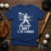 Baseball player graphic with text "How to Bunt: 1. Don't 2. Hit a Dinger" on a navy blue t-shirt