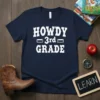 Navy t-shirt with white text "HOWDY 3rd GRADE" in a fun, Western-style font, suitable for third grade teachers