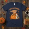 Howdy Punkin' t-shirt with a cute Highland cow, jack-o'-lantern pumpkin, and latte, surrounded by autumn leaves