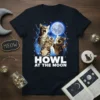 Three cats howling at a full moon with lightning on a navy blue t-shirt, text reads "HOWL AT THE MOON"