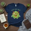 Navy t-shirt with "How's Your Day?" text and a cute green monster with glasses and bandages