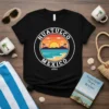 Huatulco Mexico 2024 graphic on a black t-shirt, showing a circular design with a sunset over the ocean and palm
