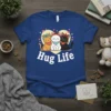 Hug Life t-shirt design with three cute cartoon cats sitting together inside a heart shape, white text below