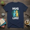 HUG LIFE! text with two smiling stick figures hugging, surrounded by concentric circles design on a navy blue t-shirt