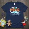 Navy t-shirt with "Hugs Not Drugs" text in orange and blue, featuring an icon of two people hugging