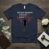 T-shirt with "HUMAN RIGHTS HUMAN RIG$$$ HUMAN RI$$$ HUMAN $$$$$$" text and a silhouette breaking free from dollar sign handcuffs