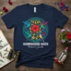 Hummingbird Haven Nature's Jewels t-shirt design featuring colorful hummingbirds circling a red hibiscus flower within a decorative mandala pattern