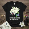 Black t-shirt featuring a white text design of "HUMMINGBIRD & WHITE LILY" with two colorful hummingbirds and white lilies