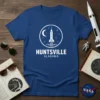 Huntsville Alabama text with a rocket launch graphic inside a circle, on a blue t-shirt