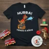 Hurra Tengo 3 Años T-Shirt with a T-Rex dinosaur dressed as a firefighter spraying water
