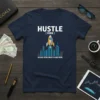 Hustle [Verb] Because Being Broke Is Hard Work text with rocket and city graphic on a navy t-shirt