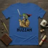 T-shirt with black text "HUZZAH" and a frog knight riding a snail, whimsical fantasy art style
