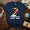 I AM MY FATHER'S WILDEST DREAM! text with a rocket and crown graphic on a navy blue t-shirt