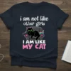Black cat lounging on a couch with remote and food, text reads "i am not like other girls I AM