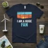 I Am A Huge Fan t-shirt with wind turbines and sunset graphic, promoting renewable energy and clean power