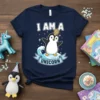 I Am A Unicorn penguin t-shirt design with white text, a penguin wearing a unicorn horn, and a blue ribbon