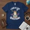 I Ask A Lot Questions T-Shirt featuring a cute owl on books with stars and planets, white text, navy shirt