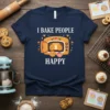 I Bake People Happy quote on a navy t-shirt with a cute graphic of cookies and cupcakes in an oven