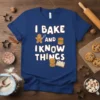 I Bake and I Know Things quote on a blue t-shirt with gingerbread man, burger, and open book graphics