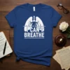 I Can't Breathe text with white lungs and heartbeat graphic on a blue t-shirt