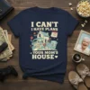 T-shirt with the text "I CAN'T I HAVE PLANS AT YOUR MOM'S HOUSE" and a charming illustration of a house