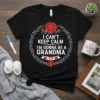 Black t-shirt with white text "I Can't Keep Calm I'm Gonna Be a Grandma" inside a floral wreath, announcing new