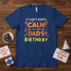 I Can't Keep Calm It's My Dad's Birthday text design with balloons and party graphics on a navy blue t-shirt