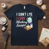 I CAN'T LYE I LOVE Making Soaps text with soap bars graphic on a navy t-shirt