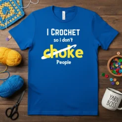 Blue t-shirt with white text "I CROCHET so I don't" and yellow text "choke" with a white line and crochet