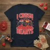 I Crush Hearts text with a red monster truck crushing broken hearts graphic on a navy t-shirt