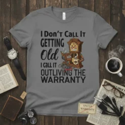 T-shirt with the funny quote "I Don't Call It GETTING Old I call It OUTLIVING THE WARRANTY" and a cartoon