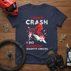 I Don't Crash I Do Random Gravity Checks quote on a navy t-shirt with a mountain biker graphic