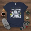 Navy t-shirt with white text "I DON'T DO THE MATCHY CHRISTMAS PAJAMAS" featuring festive graphics like candy cane, gift, and