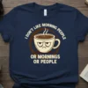 T-shirt with the quote "I DON'T LIKE MORNING PEOPLE OR MORNINGS OR PEOPLE" and a grumpy coffee cup graphic